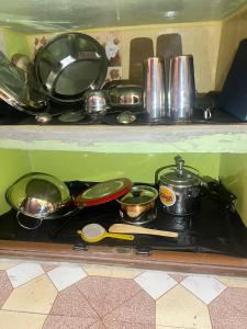 a bunch of pots and pans on a stove at Peaceful Spacious Private 1BHK Near Airport close to VIP or Jessore Rd in Nager Bazaar