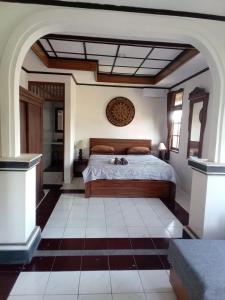 a bedroom with a large bed in a room at Lestari Homestay in Sanur