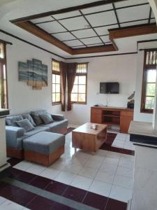 a living room with a couch and a coffee table at Lestari Homestay in Sanur