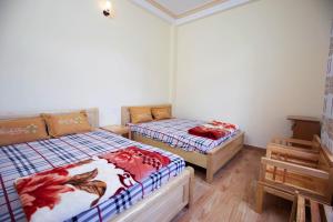 Postel nebo postele na pokoji v ubytování HUNA House