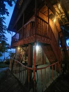 a tree house at night with the lights on at Stay N Save B&B in Oslob