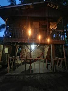 a tree house at night with lights on it at Stay N Save B&B in Oslob