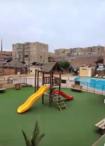 a playground with two slides and a play structure at Departamento Condominio Arica in Arica