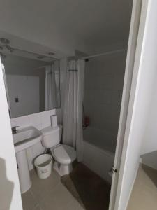 a bathroom with a toilet and a sink and a shower at Departamento Condominio Arica in Arica