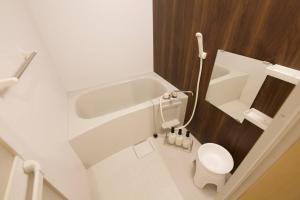 a white bathroom with a toilet and a sink at リバーサイドISHIGAKI 赤瓦A棟 in Tunugusuku +29 photos