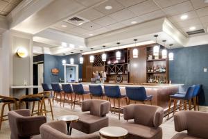 a bar in a restaurant with chairs and a counter at Four Points by Sheraton York in York