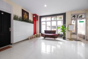 a large room with a white floor and a chair at HOTEL BALI MAKASSAR in Makassar