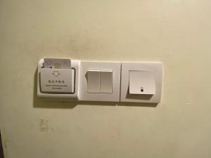 a lightswitch on a wall with two switches on it at B & B 31 Kota Kinabalu in Kota Kinabalu +19 photos