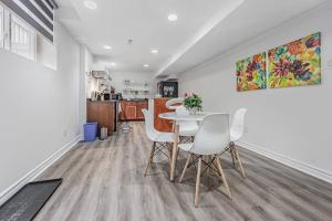 a dining room and kitchen with a table and chairs at Cozy Haven Retreat 2Bed Basement in Whitby +12 photos