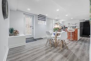 a kitchen and dining room with a table and chairs at Cozy Haven Retreat 2Bed Basement in Whitby