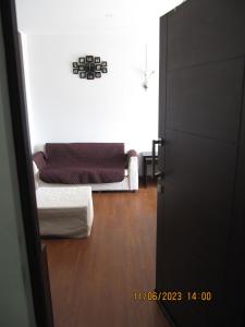 a room with a bed and a couch in it at Departamento Familiar Portales in Cochabamba