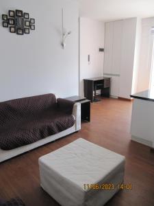 a living room with a couch and a table at Departamento Familiar Portales in Cochabamba