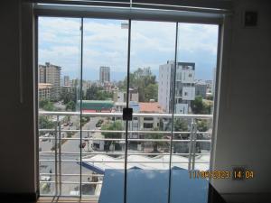 a view of a city from a large window at Departamento Familiar Portales in Cochabamba