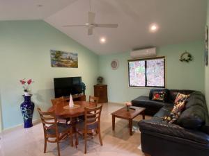 sala de estar con sofá y mesa en Rainforest Cabin in Doon Doon NSW, 