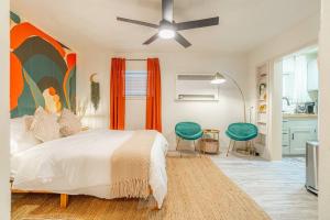 a bedroom with a large bed and a kitchen at Riverside Luxe: Stylish Designer Retreat in Reno