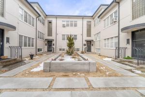 a building with a courtyard with a tree in the middle at Riverside Luxe: Stylish Designer Retreat in Reno
