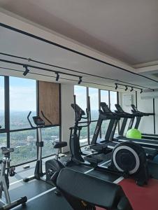 a gym with several tread machines in a room at D-29-08 / Youth City / Nilai / Infinity pool in Nilai