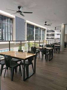 a cafeteria with tables and chairs in a building at D-29-08 / Youth City / Nilai / Infinity pool in Nilai
