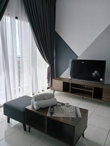a living room with a tv and a coffee table at D-29-08 / Youth City / Nilai / Infinity pool in Nilai