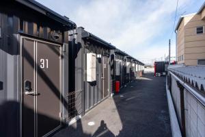 a row of train cars parked next to a building at HOTEL R9 The Yard 藤岡 in Fujioka