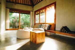 a living room with a couch and a coffee table at ZIN Berawa Villas & Bungalows in Canggu