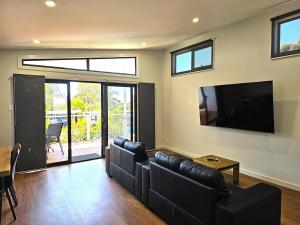 a living room with a couch and a flat screen tv at Murray Bridge Tourist Park in Murray Bridge