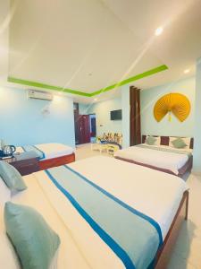 a hotel room with two beds and a room with at Anh Vu Hotel Phú Quốc in Phu Quoc