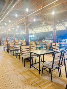 a row of tables and chairs in a restaurant at Anh Vu Hotel Phú Quốc in Phu Quoc