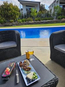 a tray of food and a glass of wine on a table at Murray Bridge Tourist Park in Murray Bridge