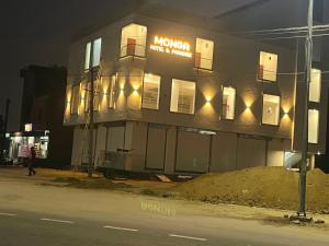 a building on the side of a street at night at Monga Hotel & Paradise in Hanumāngarh