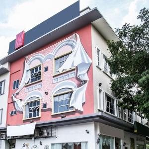 a building with a large painting on the side of it at Seeds Hotel Shah Alam Section 19 in Shah Alam