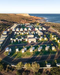 an aerial view of a resort complex next to the ocean at Kalbarri Red Bluff Tourist Park in Kalbarri