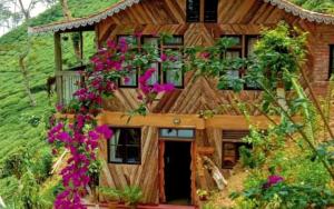 a house with flowers in front of it at Koilee Homestead by StayApart in Darjeeling