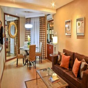 a living room with a couch and a table at Royal Garden Hotel in Ozamis