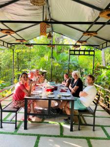 a group of people sitting at a picnic table at Fab Valley Homestay in Munnar
