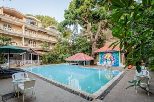 a swimming pool in front of a building at Joia Do Mar Resort - Calangute in Calangute