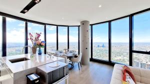 a kitchen and living room with a view of the city at 84 Floor/Splendid View/free car park/3B/Near Crown in Melbourne