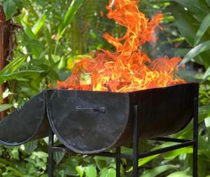 a fire in a grill with flames in it at VIEW guesthouse & bistro at goyambokka in Tangalle