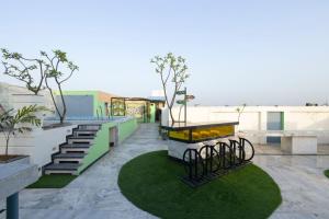 a balcony with stairs and plants on a building at Hotel Sahibs Lighthouse - Rooftop Swimming Pool in Agra