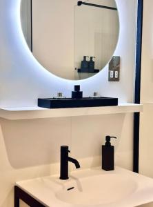 a bathroom with a sink and a mirror at 34 Cliff Edge 2nd floor Newquay luxury sea-view residence in Newquay