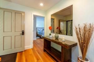 a hallway with a mirror and a wooden table at Stunning ocean view! 2-2 in the heart of Wailea in Wailea