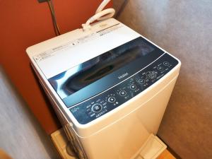 a microwave oven sitting on top of a refrigerator at Rakuten STAY Hakata Gion 401 Superior Room in Fukuoka