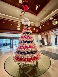 a christmas tree made out of cupcakes on a table at Radisson Collection Hyland Shanghai in Shanghai