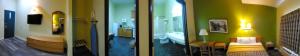 two views of a room with a bathroom and a bedroom at Quality One Motel in Weatherford