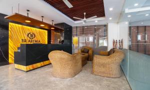 a lobby with wicker chairs and a sign that reads bantam at Treebo Trend Brahma - Wayanad in Mananthavady