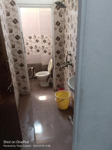 a bathroom with a toilet and a sink at Durga Pride in Kurnool