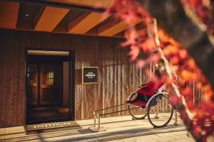 a person sitting in a wheelchair in front of a building at Hotel Indigo Hakone Gora, an IHG Hotel in Hakone