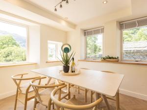 a dining room with a table and chairs at Langdale Boulders in Ambleside