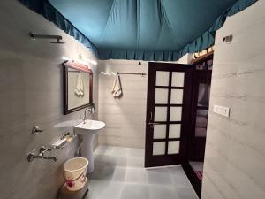 a bathroom with a sink and a mirror at Royal Rajasthan Resort in Sīkar