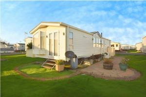 a tiny house in the yard of a house at The Meridan Lodge - Platinum 2024 Season in Clacton-on-Sea